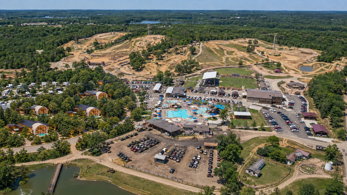 Adrenaland wider park concept showing off-road tracks, matching arched pool villas in a wooded lodging area, RV sites, water attractions and event space.